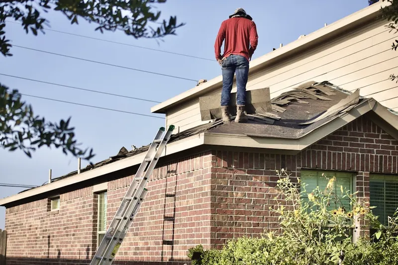 Professional roofer working on a residential roof in North Union
